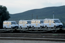Air-conditioned touring vehicles transported together on the train. 